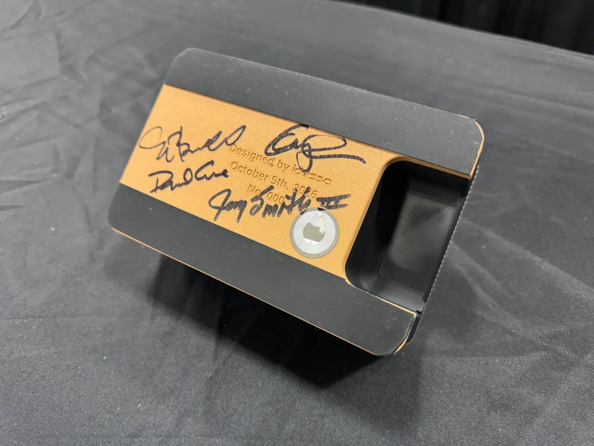 The copper plate of an Arkade controller, signed in black marker four times.